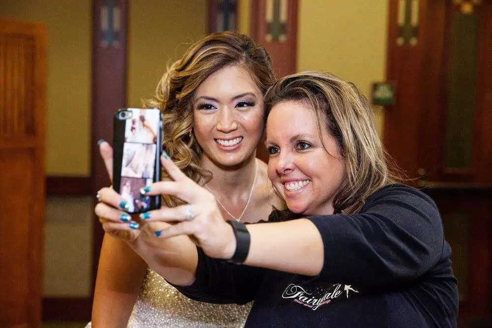 Tara Fontana, owner of Fairytale Hair & Makeup, poses with a bridal makeup client on her wedding day.