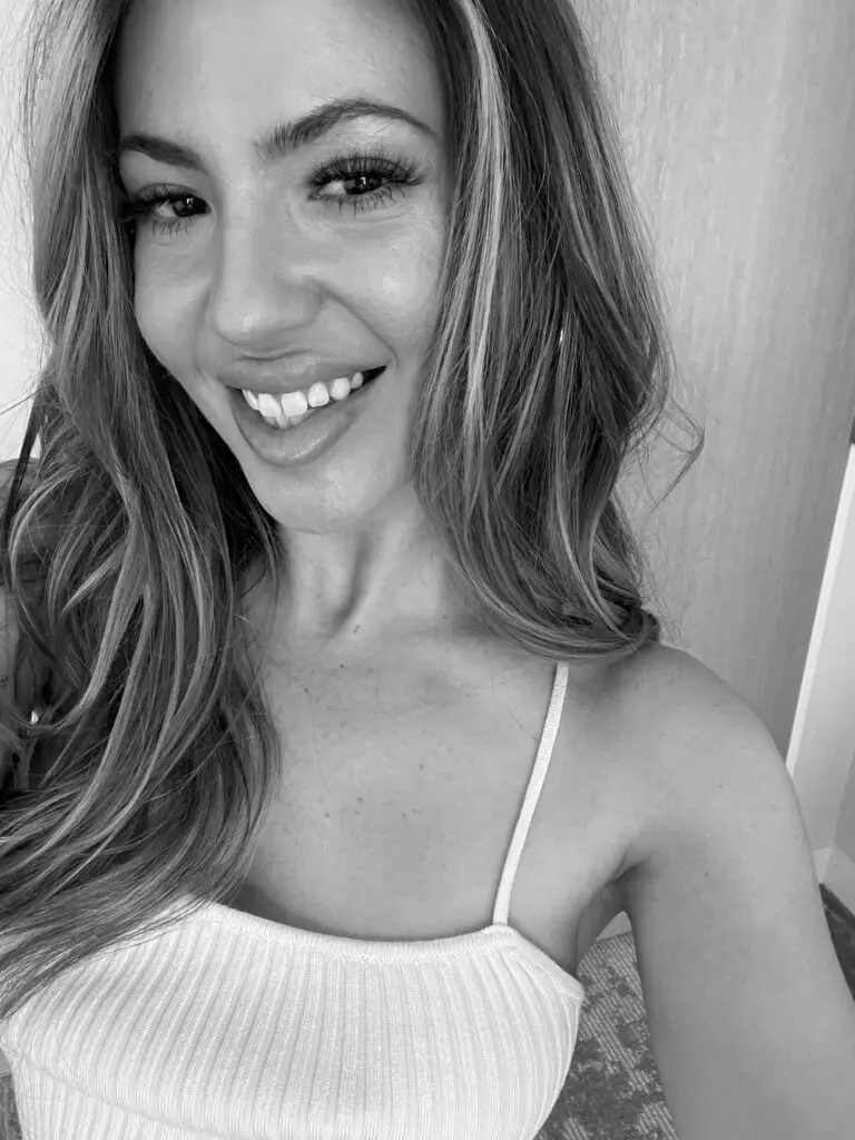 Kim, a Los Angeles-based mobile hairstylist at Fairytale Hair & Makeup, smiles.